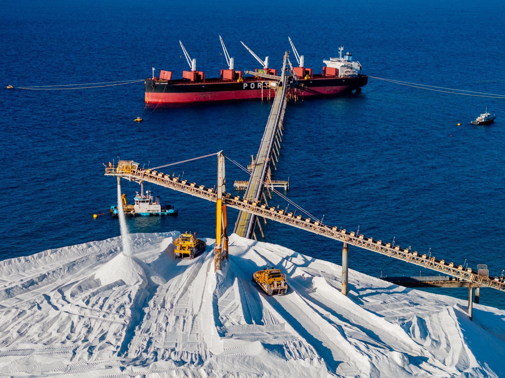 Aerial view of salt stockpiles and ship loading at Cape Cuvier, Lake Macleod operation